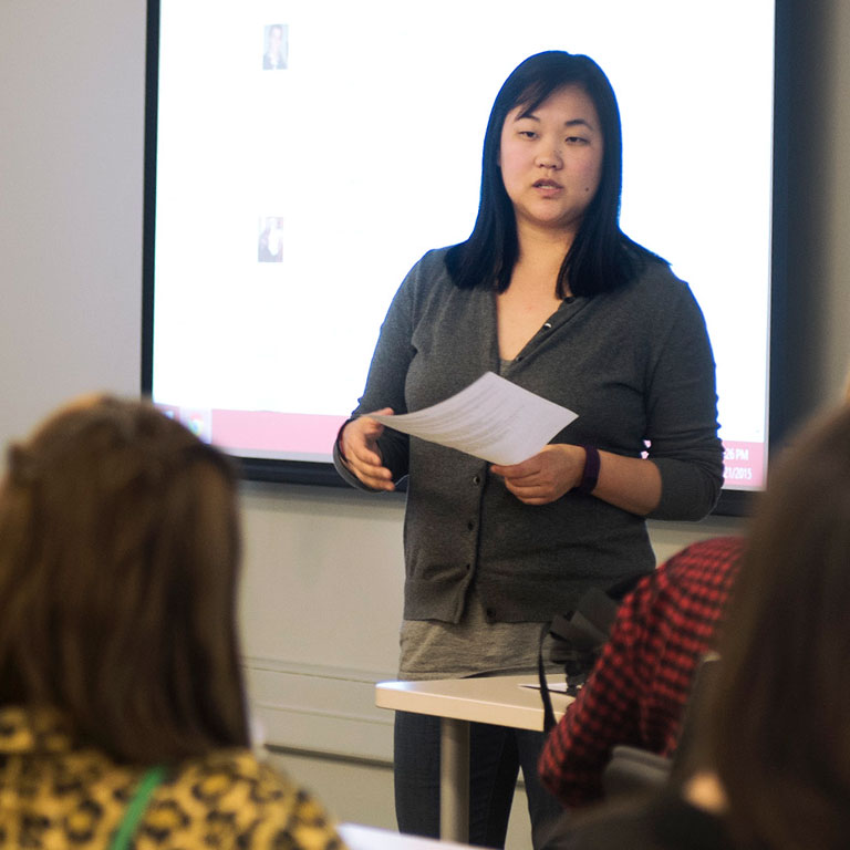 An informatics faculty member speaks in front of a class.